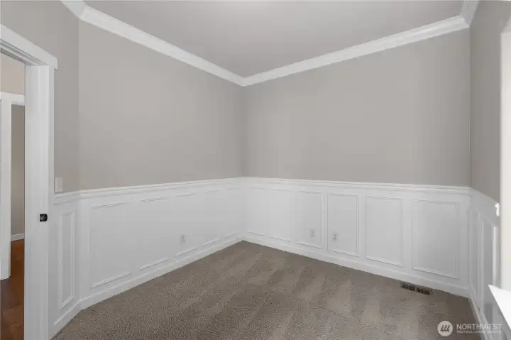Featuring classis wainscoting, the main-level den provides an excellent office or flex space, with the flexibility to adapt to your family's changing needs.