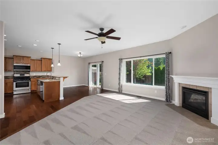 Light filled with high ceilings and plenty of windows, plus siding doors to a cozy covered patio.