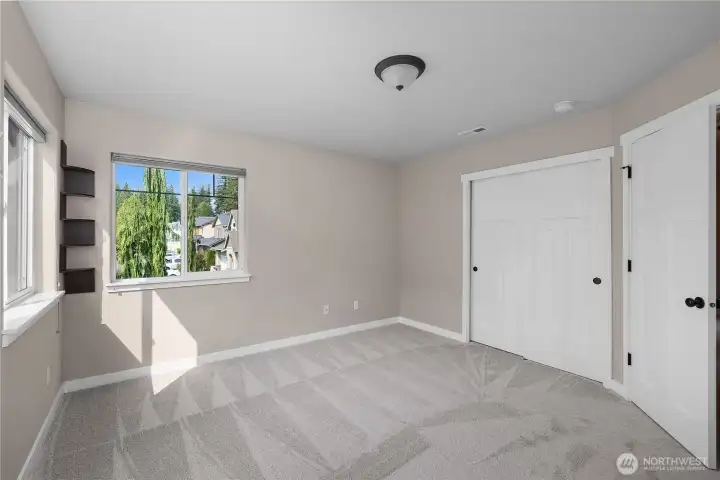 Deep closets in bedroom and bathroom offer plenty of storage space.