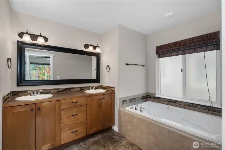 Luxurious 5-piece primary bath with dual sinks, soaking tub, and separate shower.