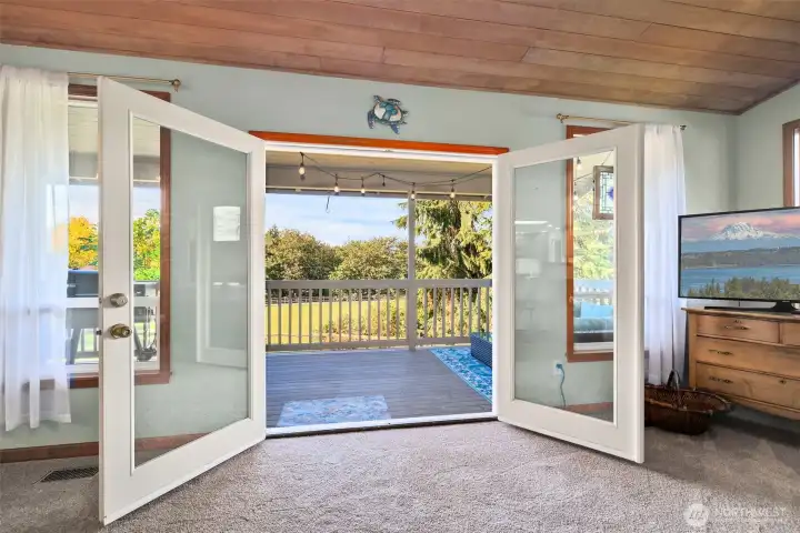 French doors off the living room open to a spacious covered deck—perfect for indoor-outdoor living