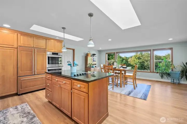 Dream kitchen with Bosch appliances, granite finishes, and open flow to a sun-filled great room