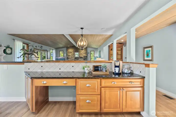 A second look at the desk nook reveals additional cabinetry and extended workspace. Don’t miss the stunning wood ceiling features that add warmth and character to the space