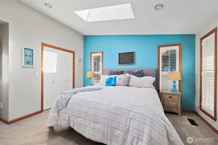 Natural light pours in through skylights and oversized windows, creating a warm and inviting ambiance.
