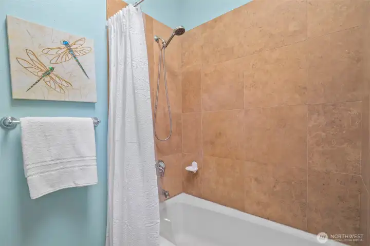 Sophisticated tile surround elevates the shower while offering easy maintenance.