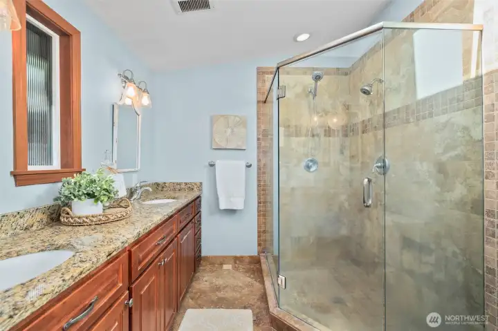 Additional bathroom boasts granite countertops and a spacious double vanity and large shower