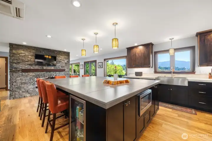 Another great view of this wonderful kitchen with custom wood burning double sided fireplace to warm you up on those cool winter evenings.