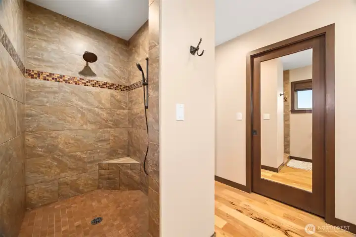 Large primary custom tiled shower.