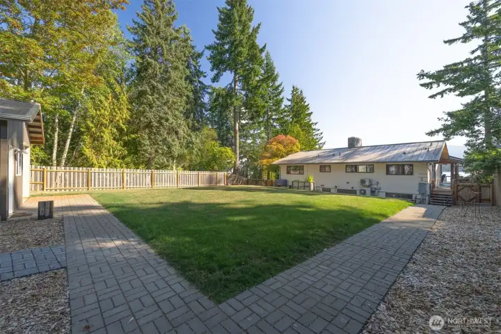 Large, flat fenced back yard with shop, custom sauna and cold plunge.