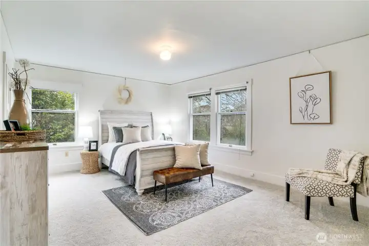 The spacious primary bedroom features brand new carpet and fresh paint, making move-in a breeze. All bedrooms boast two sets of windows for plenty of natural light.