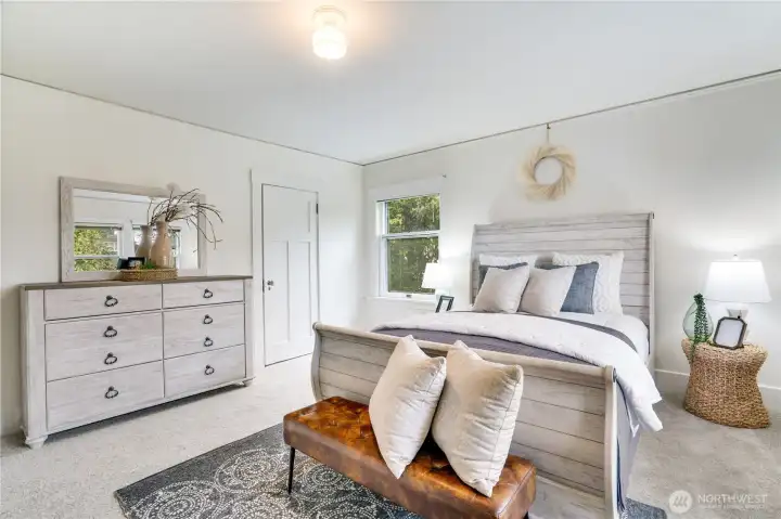 The small walk-in closet in the primary bedroom features added shelving and smart organization.