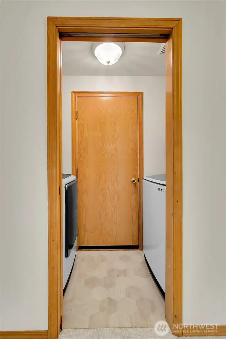 Utility room off garage with washer and dryer