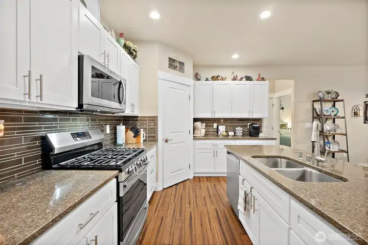 Kitchen with sink in island and propane range.