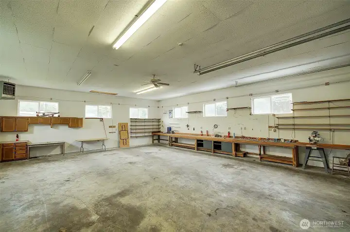 The shop interior is lined with work benches and also features a gas overhead shop heater.