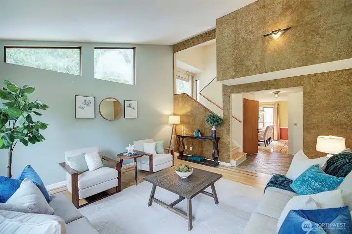 The dining room is finished with hardwood floors and features a vaulted ceiling.