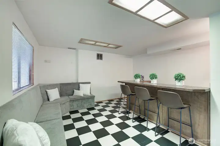 Built in benches offer storage space and the wet bar area feature bar stool seating.  Get your big screen TV mounted and you're ready to entertain!