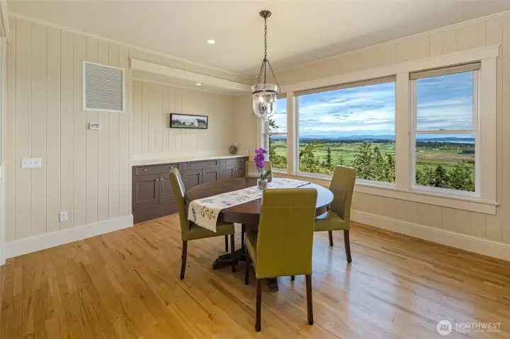 Dining area with large picture windows showcasing breathtaking valley and water views—perfect for everyday meals or gatherings.