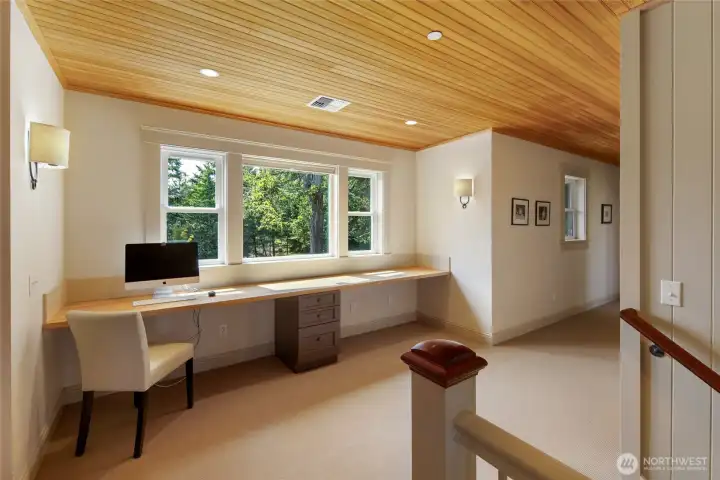 Light-filled upper landing with built-in workspace and flexible use for office, study, or creative space.