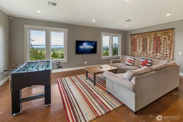 Spacious lower-level living area with abundant natural light, perfect for recreation, media, or guest lounge space.