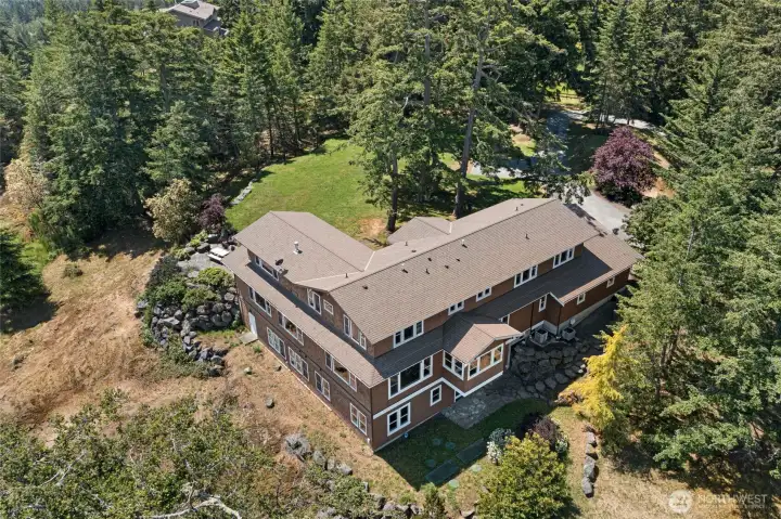 Spacious 5,800 sq ft home surrounded by mature evergreens, offering privacy, tranquility, and classic Pacific Northwest appeal.