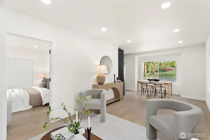 Open-concept living and dining area with recessed lighting.