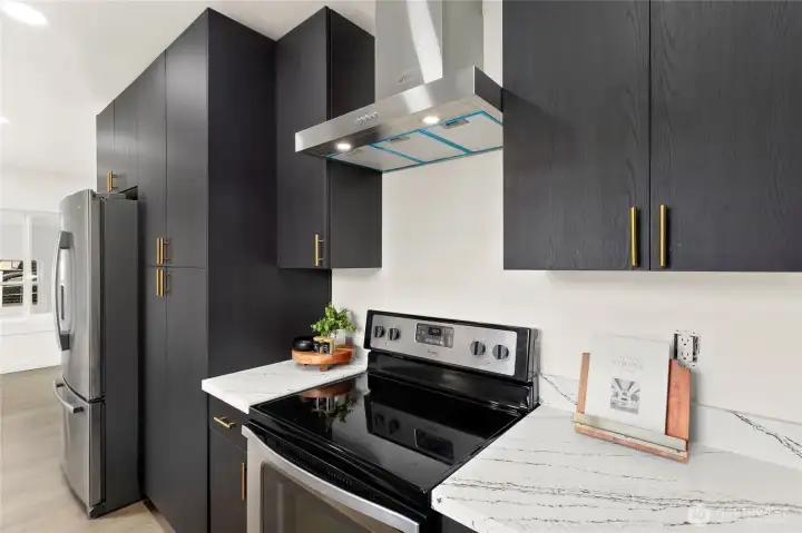 Bright kitchen with window over sink and gold-accent fixtures.
