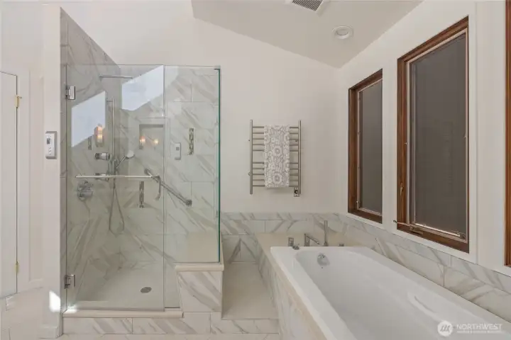 Soaking tub and walk-in shower in the primary bathroom.