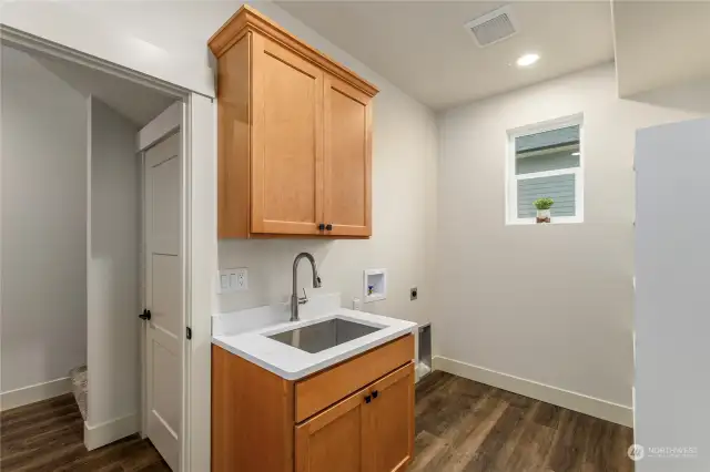 Utility/ laundry room on main level with built in storage