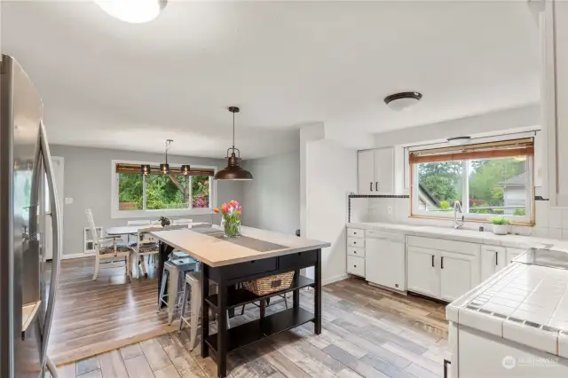 Eat-in kitchen connects to family room which leads to bedroom hallway.