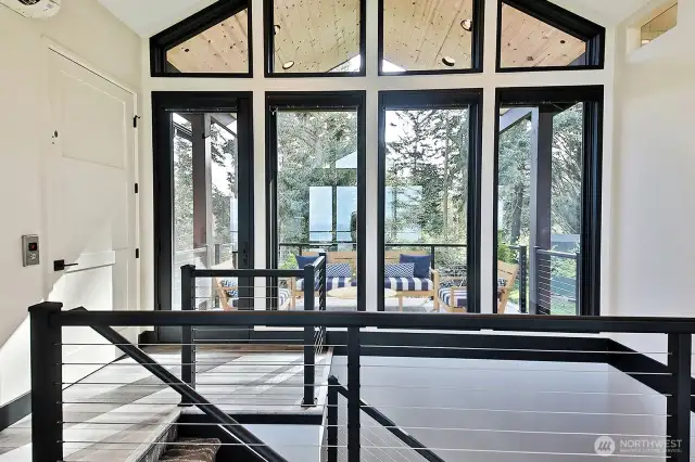 Coming up to the main level. Elevator door to the left or come up the stairs. Front covered deck.