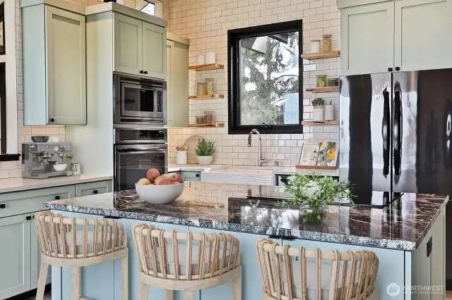 Granite countertops. Electric induction stove with down draft. Oven/microwave, dishwasher & refrig. Subway tile surround.