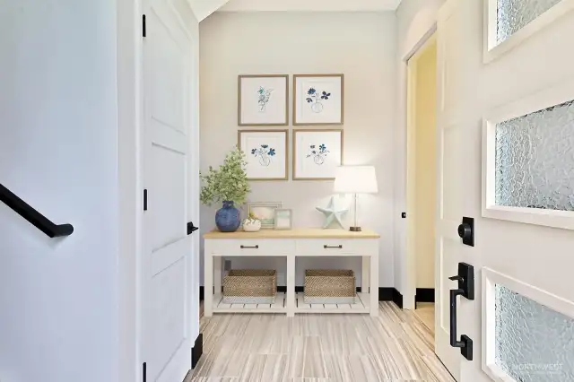The foyer leads to the mother-in-law suite. The elevator access is behind the open door to the main level, or you can take the stairs to the left. A nice-sized closet is behind the shut door. Garage access is to the left.
