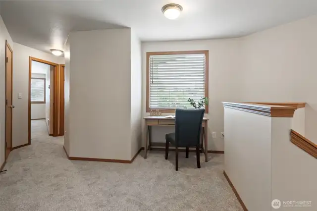 There is a little nook at the top of the stairs for a desk or work area.