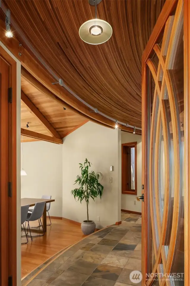 Inside, wood-wrapped ceilings and slate floors set the tone, while artful angles and graceful curves add visual intrigue throughout