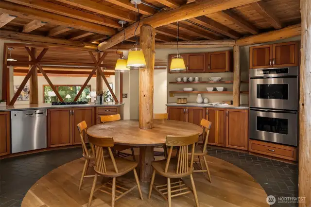 The open kitchen is outfitted with high-end appliances, including a gas Viking range, Bosch dishwasher, Sub-Zero refrigerator, and Thermador double oven—truly a chef’s dream.
