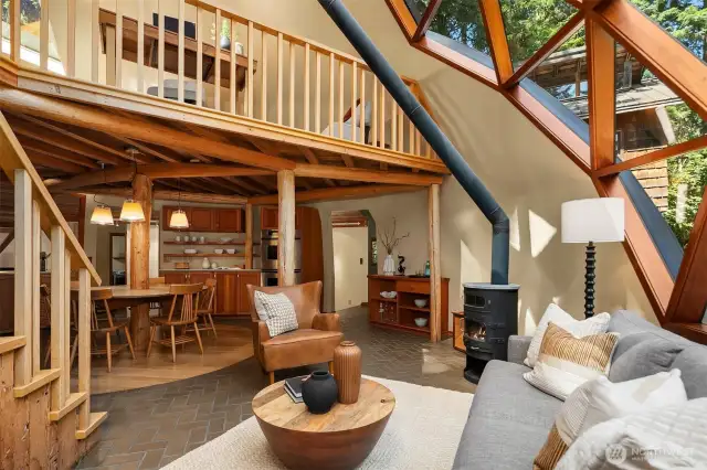 Cozy up by the wood-burning fireplace, where geometric dome windows surround you with views of the forest, making it feel like you're outdoors even in the heart of winter.