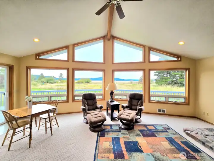 The morning sunrise will shine through the living room windows.