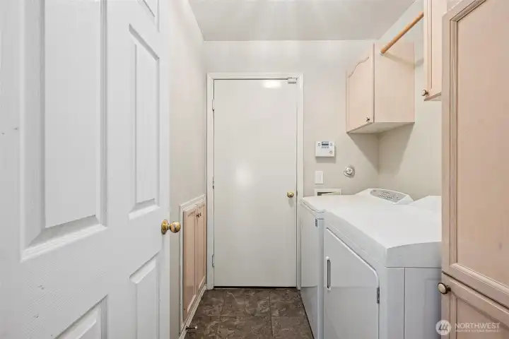 Utility Room off Garage. Spacious Storage leads under stairs. Drying Rack & the Perfect Cabinet for Vacuum/Mop/Broom