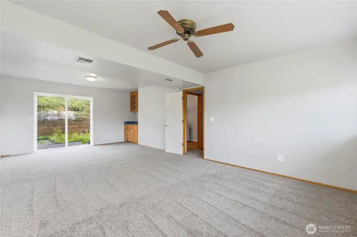 Another view of the rec room, with slider to back yard and wet bar.