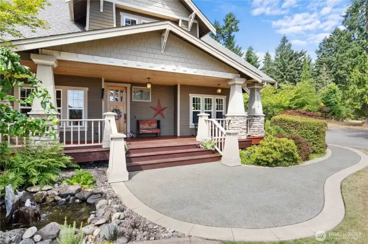 Well manicured with mature landscaping and a welcoming porch