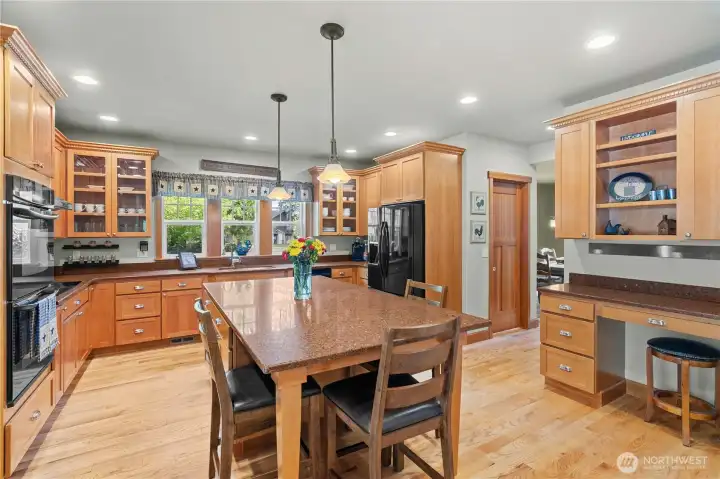 Quality gourmet kitchen with oversized island, desk and abundant cabinets and pantry