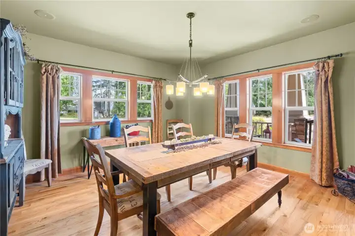 Windows surround this formal dining room with room for the largest table
