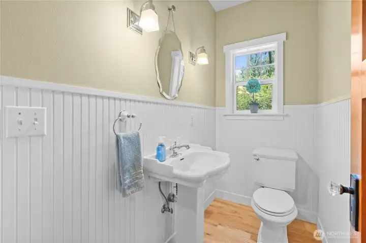 Main floor powder room with chair railing compliments the character of the home