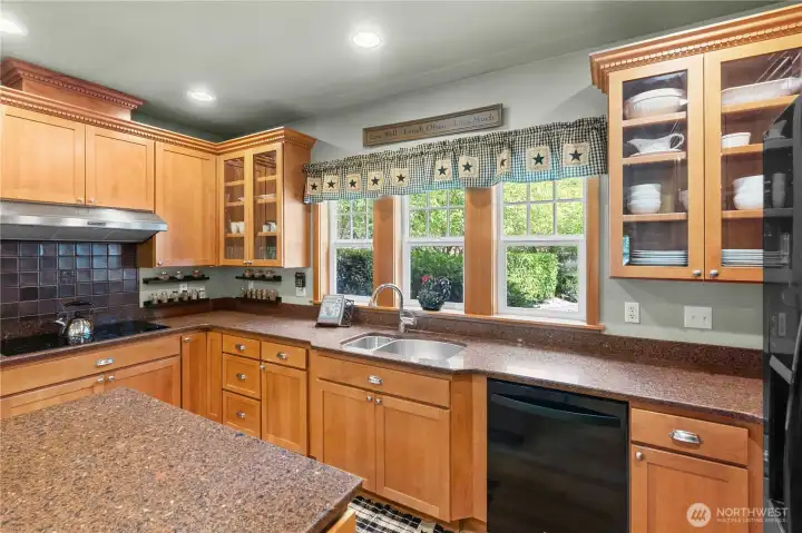 Little details like glass cabinets and extra windows over the sink make this a charming space