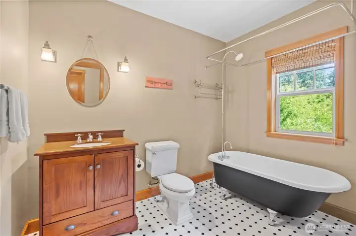 With a nod to yesteryear, this bathroom features a clawfoot tub and classic tiling