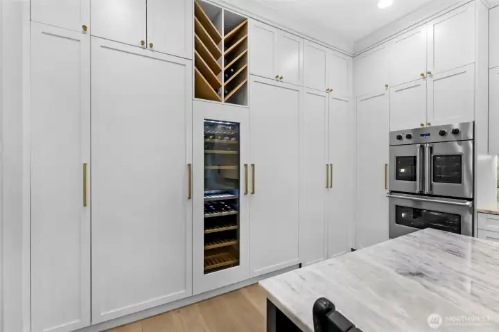 Hidden "Butler Pantry" access. Freezer on left, wine fridge in the middle and Refer on the right.