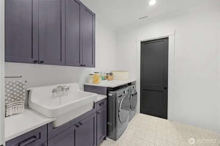 Extra Large Laundry Room with pocket door to the North Wing Primary Suite Closet.