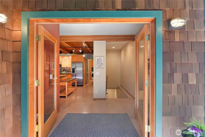 Entry foyer to main floor amenities and stairs to multipurpose daylight basement.