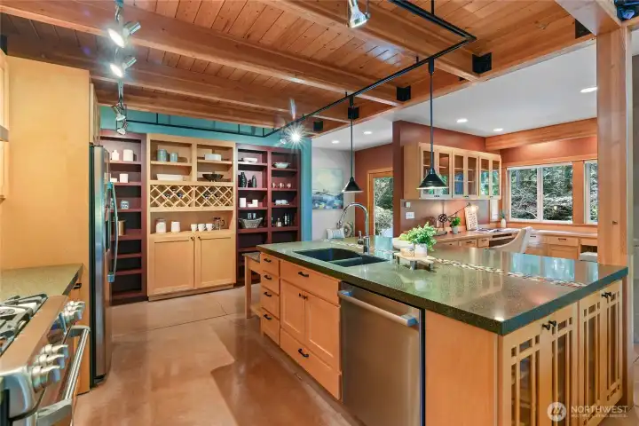 Kitchen view toward entry foyer with built in home office space to the right.