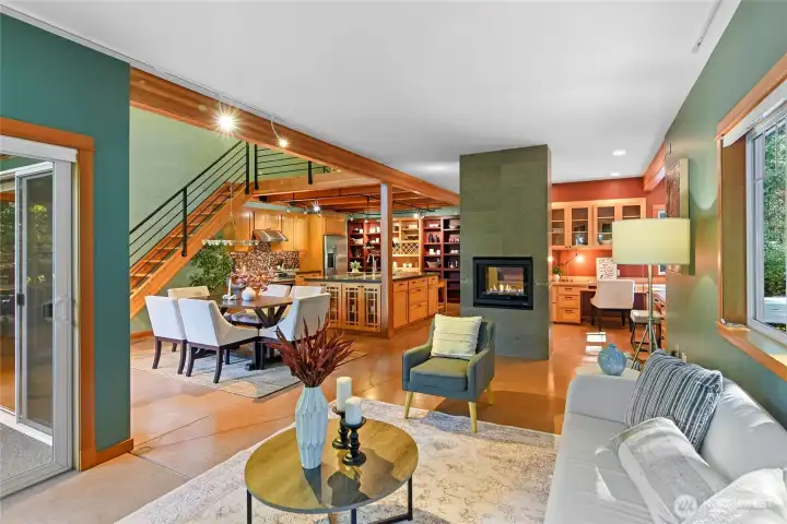 View from living room to dining room, kitchen, LP fireplace, and home office.